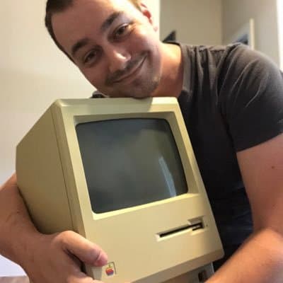 Robert Dale Smith hugging an original 1984 Macintosh